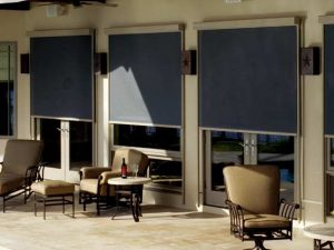 exterior photo of a home with solar shades halfway down