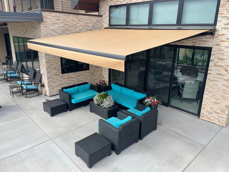Tan Eclipse retractable awning extended over a patio with outdoor seating