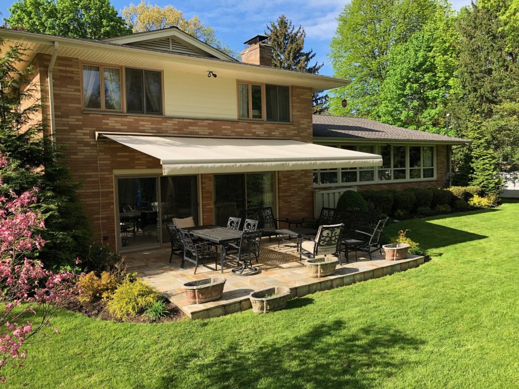 Eclipse Premier retractable awning shading a brick home patio